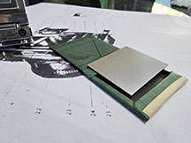 A color photo of an original Compass Camera dry plate holder and plate, disected.