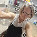 Me, in the apron, in my darkroom.